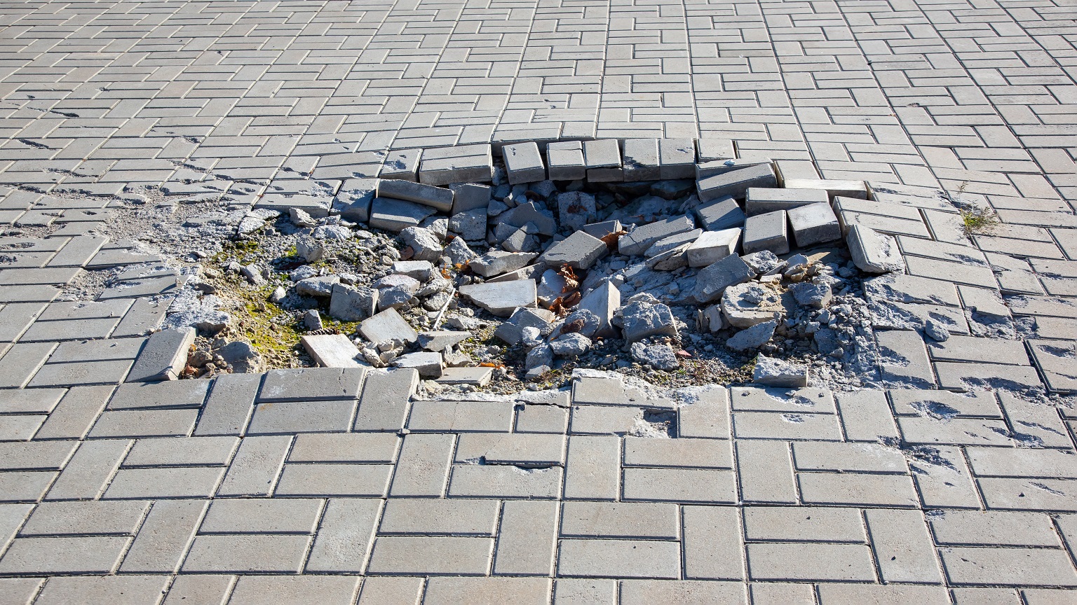 crater from a mine explosion on the bridge square of the city during the war in Ukraine